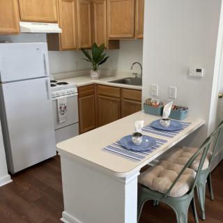 Cozy kitchen and dining space with wooden cabinets and a small dining table.