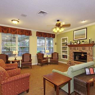 A cozy living room with comfortable seating and a fireplace.