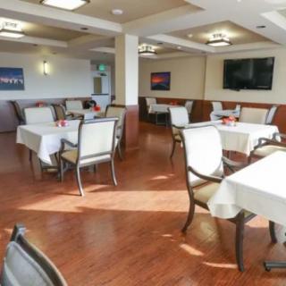 A spacious and clean dining room with neatly arranged tables and chairs.
