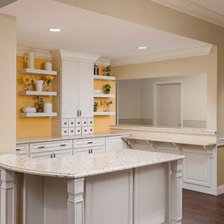 A modern kitchen with white cabinetry and a central island.