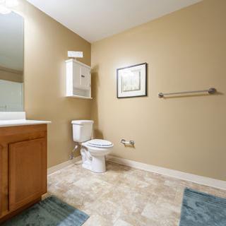 A well-lit bathroom featuring essential fixtures and neutral colors.