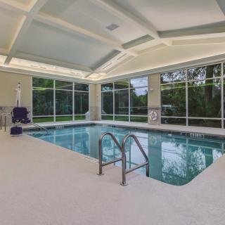 A spacious indoor swimming pool with large windows and ample natural light.