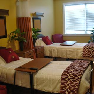 A cozy and inviting guest room featuring twin beds, warm colors, and decorative elements.