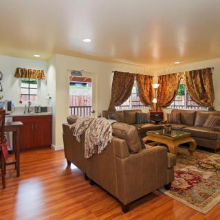 A cozy living room with sofas, a coffee table, and decorative curtains.