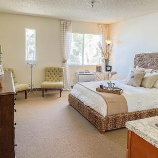 A cozy bedroom with stylish decor and natural light.