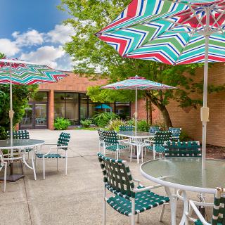 A vibrant patio with colorful umbrellas and comfortable seating provides a perfect spot for outdoor relaxation.