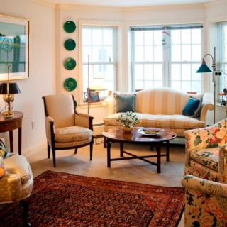 Cozy and elegantly decorated living room with comfortable seating and natural light.