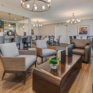A modern lounge area with comfortable seating and a well-lit bar.