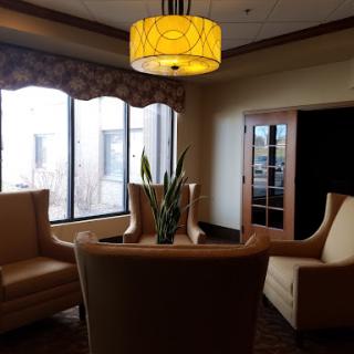 A cozy lounge area featuring modern furniture and warm lighting.