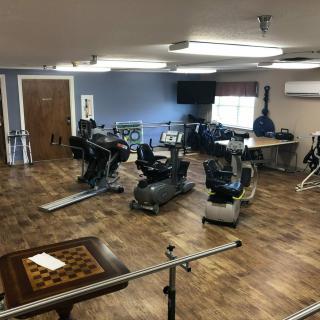 A well-equipped gym room with various exercise machines and equipment.