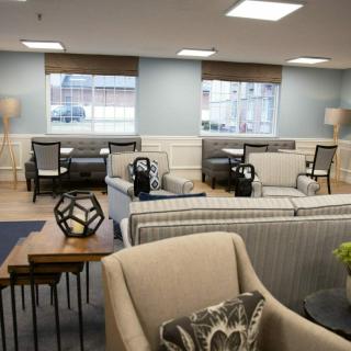 A cozy lounge area with comfortable seating and ample natural light.