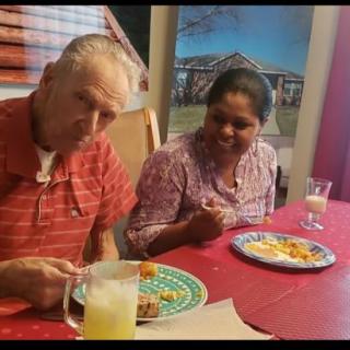 Two people enjoying a meal together at a dining table.