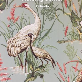Illustrated cranes amidst floral patterns.