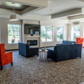 A modern living room with stylish furniture and a cozy fireplace.