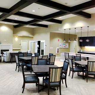 Modern dining area with multiple tables and chairs in an open, well-lit space.