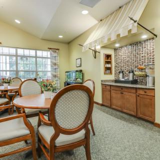 A cozy dining area with a kitchenette and elegant furniture.