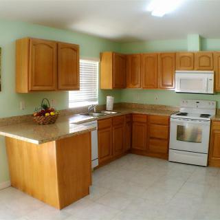 Spacious kitchen with wooden cabinets and modern appliances.