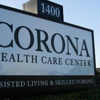 Sign for Corona Health Care Center offering assisted living and skilled nursing services.