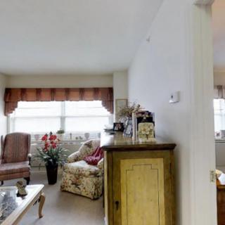 A cozy living room with comfortable seating and decorative elements.