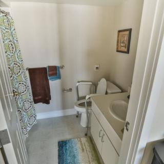 A small bathroom with a toilet, sink, and shower curtain.