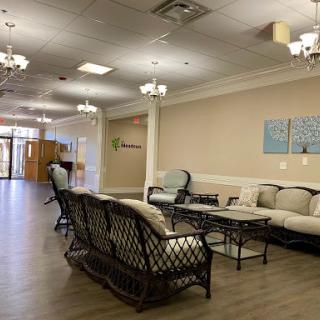 A spacious and elegantly designed lobby area featuring comfortable seating and modern lighting fixtures.