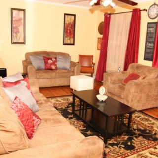 A cozy living room with comfortable sofas, a central coffee table, and warm decor.