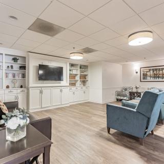 A modern living room with comfortable seating and a large TV.
