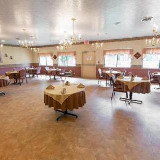 A spacious and elegantly designed dining area with tables set for guests.