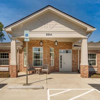Front view of a brick building with a parking space.