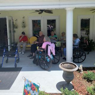 Residents enjoying a sunny day on the porch.