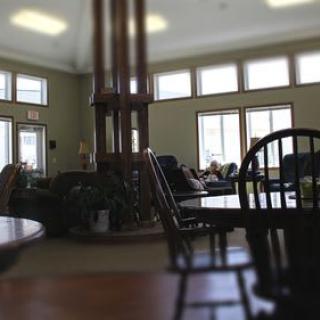 A cozy interior with seating arrangements and large windows.