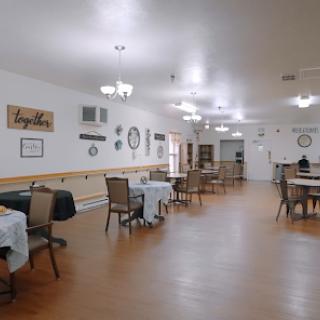 A spacious and inviting dining area with tables, chairs, and decorative elements.