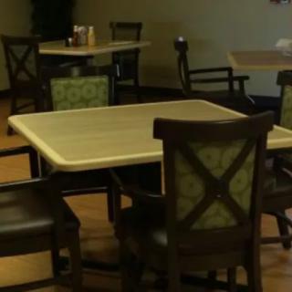 An empty dining area with tables and chairs arranged neatly.