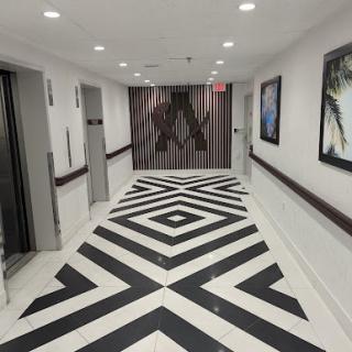 A stylish hallway showcasing modern design with a striking black and white geometric floor pattern.