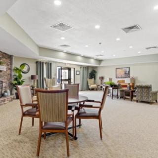 A spacious and brightly lit living area featuring comfortable seating and a modern design.