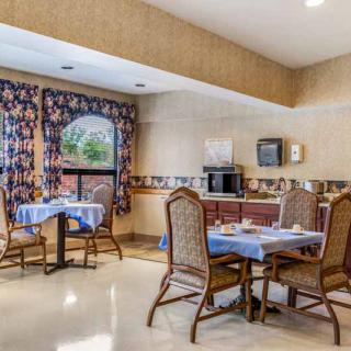 A cozy dining area with neatly set tables and traditional decor.