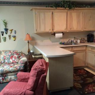 Cozy kitchen area with seating and decorative elements.