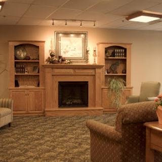A cozy living room featuring a wooden fireplace and comfortable seating.