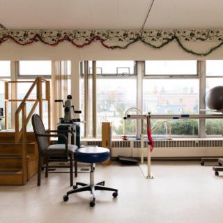 A rehabilitation room equipped with therapy and exercise equipment.