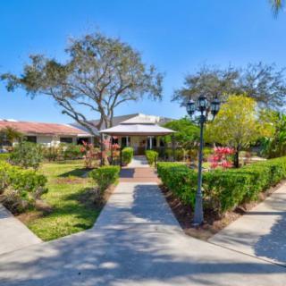 A charming house with a beautifully landscaped garden and pathways.
