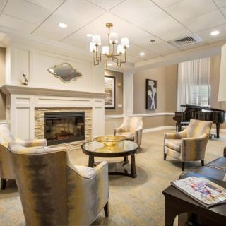 Elegant living room with a cozy fireplace and grand piano.