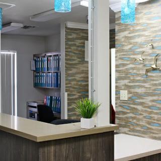 A modern reception area featuring stylish furniture and decorative elements.