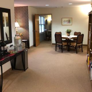 A cozy office space with a table, chairs, and a water dispenser.