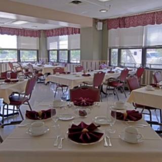 An elegantly arranged dining room with neatly set tables and chairs.