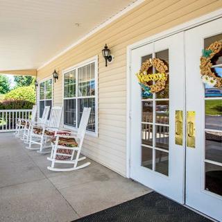 A cozy porch with rocking chairs and decorative glass doors.