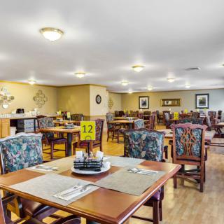 A spacious dining area with neatly arranged tables and chairs.