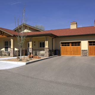 A suburban house with a spacious driveway and attached garage.