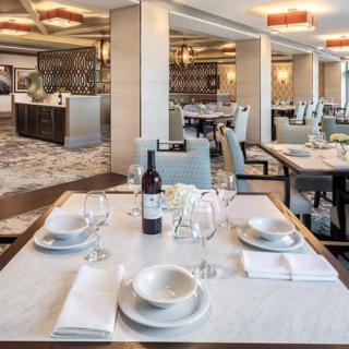 An elegantly set dining table in a modern, empty restaurant.