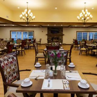 An elegant restaurant dining area with neatly set tables and soft lighting.