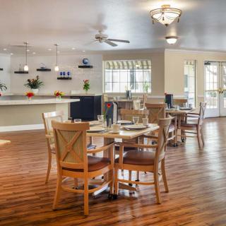 A modern dining area with wooden furniture and stylish lighting.